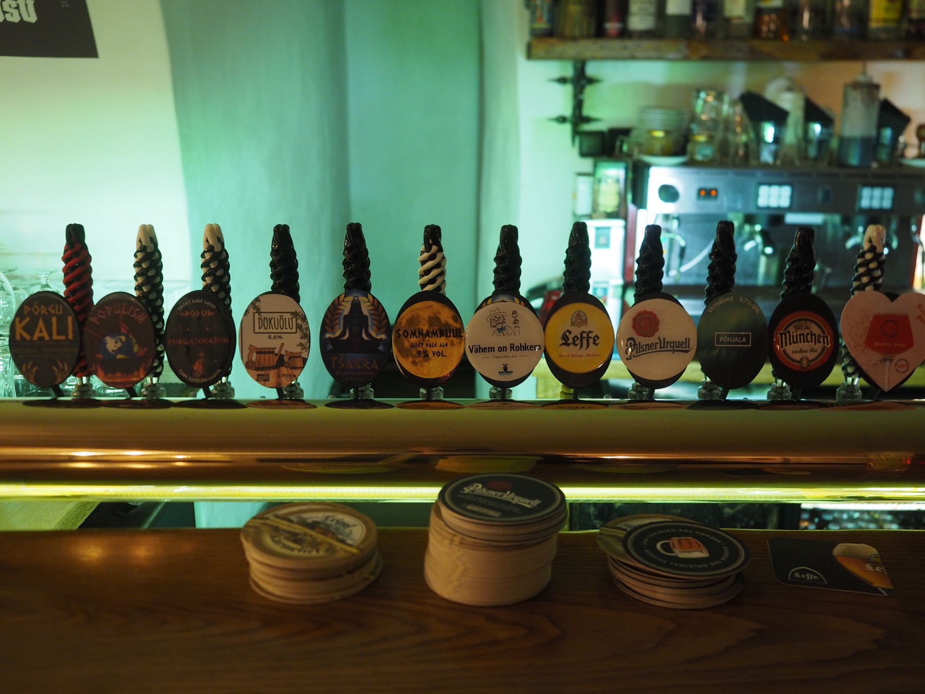 A row of beer taps at a bar